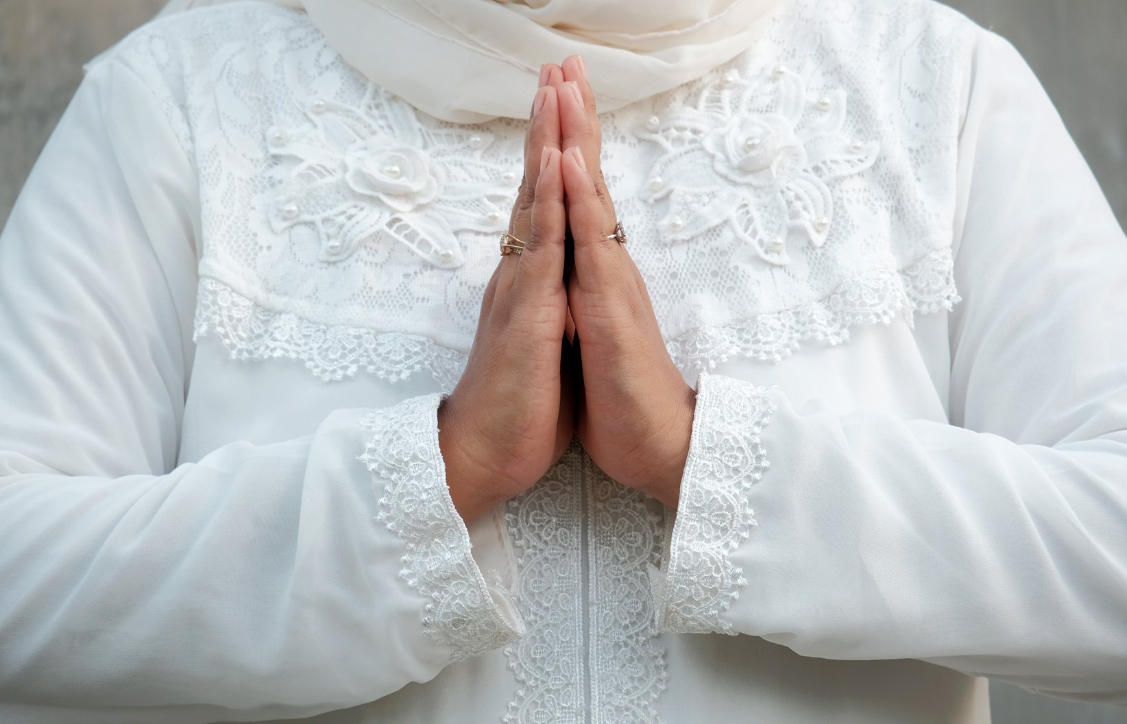 Person Joining Hands as Symbol of Prayer